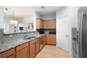 Spacious kitchen with granite countertops, stainless steel appliances, wood cabinets, and tiled backsplash at 1975 Nocturne Dr # 2303, Alpharetta, GA 30009