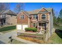 Beautiful two-story home with brick and siding, two-car garage and landscaped front yard at 7933 Heathmore Dr, Fairburn, GA 30213