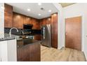 Spacious kitchen with granite countertops, dark wood cabinets, and stainless steel appliances at 860 Peachtree Ne St # 2209, Atlanta, GA 30308