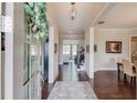 Welcoming foyer with dark hardwood floors, neutral walls, elegant decor, and views into other rooms at 1074 Nash Springs Cir, Lilburn, GA 30047