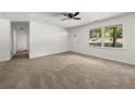 Bright living room with neutral carpet, large windows offering backyard views, and a welcoming entrance at 37 S Forty W Pass, Hiram, GA 30141