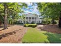 Beautiful home exterior with manicured lawn, mature trees, and a long driveway at 3818 Sweet Bottom Dr, Duluth, GA 30096