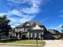 Beautiful brick home with well-kept lawn, attached garage, and long driveway, offering ample parking space at 2506 Monta Vista Way, Hoschton, GA 30548