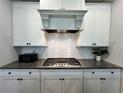 Modern kitchen featuring white cabinets, stainless steel appliances, and granite countertops at 2506 Monta Vista Way, Hoschton, GA 30548