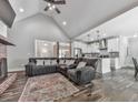 Spacious living room featuring a vaulted ceiling, fireplace, and an open layout to the kitchen at 2700 Sam Nelson Rd, Canton, GA 30114