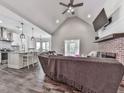 Open concept living area with vaulted ceiling, fireplace, and seamless transition to the modern kitchen at 2700 Sam Nelson Rd, Canton, GA 30114
