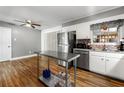 Spacious kitchen featuring stainless steel appliances, white cabinets, and modern flooring at 1082 Green Valley Nw Dr, Conyers, GA 30012