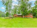 Classic brick ranch-style home with green shutters and a spacious yard, blending comfort and nature at 201 Smithstone Path, Fayetteville, GA 30214
