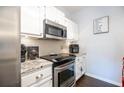 Updated kitchen features stainless steel appliances, granite countertops, and white cabinets at 2700 Pine Tree Ne Rd # 2204, Atlanta, GA 30324