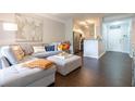 Cozy living room with a sectional sofa, ottoman coffee table, and view to the kitchen at 2700 Pine Tree Ne Rd # 2204, Atlanta, GA 30324