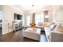 Bright living room featuring modern decor, including a plush sectional, mirrored cabinet, and access to an outdoor space at 2700 Pine Tree Ne Rd # 2204, Atlanta, GA 30324