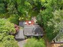 An aerial view of a home surrounded by lush greenery and mature trees at 4105 Peachtree Dunwoody Ne Rd, Atlanta, GA 30342