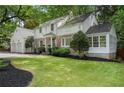 Attractive two-story home featuring brick and siding with an attached two-car garage at 4105 Peachtree Dunwoody Ne Rd, Atlanta, GA 30342
