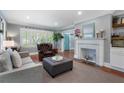 Bright living room with fireplace, hardwood floors, and a comfortable seating arrangement at 4105 Peachtree Dunwoody Ne Rd, Atlanta, GA 30342