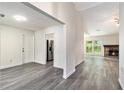 Open-concept living area with a fireplace, sleek floors, and ample natural light at 520 Cranberry Pl, Roswell, GA 30076