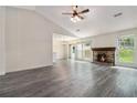Bright living room featuring stylish floors, a stone fireplace, and backyard views at 520 Cranberry Pl, Roswell, GA 30076