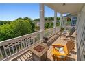 Relaxing balcony with stylish seating, a fire pit, and scenic views, perfect for outdoor enjoyment at 7120 Lullwater Rd, Cumming, GA 30040