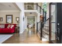 Inviting foyer with hardwood floors, staircase, and views into the formal living areas at 12350 Stevens Creek Dr, Alpharetta, GA 30005