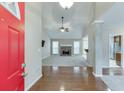 Inviting home foyer featuring hardwood floors, leading into a spacious living room with a stone fireplace at 2682 Freemans Walk Path, Dacula, GA 30019