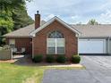 Charming brick house with a two-car garage and manicured lawn at 3024 Orchard Ridge Cir, Duluth, GA 30096