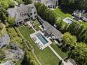 Aerial view showcasing the estate, pool, and lush landscaping that creates a private oasis at 3888 Peachtree Dunwoody Rd, Atlanta, GA 30342