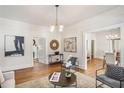 Inviting living room featuring hardwood floors, modern light fixtures, and neutral paint at 1050 Lawton Sw Ave, Atlanta, GA 30310