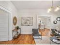 Bright living room featuring hardwood floors, modern light fixtures, and neutral paint at 1050 Lawton Sw Ave, Atlanta, GA 30310