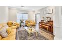 Cozy living room with hardwood floors, ample lighting, and comfortable seating arrangements at 1500 Highland Farm Dr, Suwanee, GA 30024