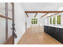Inviting open kitchen with hardwood floors, beamed ceilings, and a center island at 208 Regester Way, Peachtree City, GA 30269