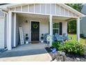 Cozy covered front porch features tasteful decor, seating, and a welcoming atmosphere at 354 Jada Ln, Villa Rica, GA 30180