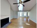 Inviting living room with a fireplace, ceiling fan, and hardwood floors for a cozy and comfortable atmosphere at 1575 Wynfield Dr, Auburn, GA 30011