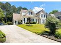 Charming home featuring a well-manicured lawn, lush landscaping, and traditional architectural details at 1739 Praters Pt, Dacula, GA 30019