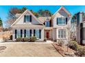 Charming home featuring a well-manicured lawn, lush landscaping, and traditional architectural details at 1739 Praters Pt, Dacula, GA 30019