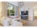 Cozy living room with a large window, stylish furniture, and a view leading into the Primary bedroom at 1820 Peachtree St # 311, Atlanta, GA 30309