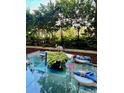 Cozy outdoor patio with glass table and seating, surrounded by lush greenery at 1820 Peachtree St # 311, Atlanta, GA 30309