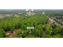 Aerial view of a property at 3370 Ashton Drive near the Lambert High School with lush green tree coverage at 3370 Ashton Dr, Suwanee, GA 30024