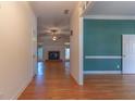 Inviting foyer with hardwood floors, leading to a spacious living area with a fireplace and ample natural light at 1210 Lancelot Ct, Loganville, GA 30052