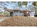 Charming home with covered parking, manicured lawn, and inviting entrance at 2608 Barge Sw Rd, Atlanta, GA 30331