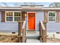 Close-up of the front door, showcasing the bright orange color and welcoming entrance at 2608 Barge Sw Rd, Atlanta, GA 30331