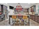 Spacious kitchen features stainless steel appliances, granite countertops and a large center island at 412 Live Oak Pass, Loganville, GA 30052