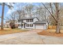 Charming two-story home with a white exterior, black shutters, and attached garage at 2328 Carnes Rd, Jonesboro, GA 30236