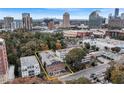 Aerial view of a city apartment building, surrounded by trees and city skyscrapers at 3649 Peachtree Ne Rd # 201, Atlanta, GA 30319