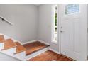 Bright entryway with hardwood floors and a white door with decorative glass at 1023 Chartley Sw Dr, Lilburn, GA 30047