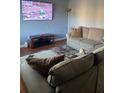 Spacious living room featuring hardwood floors, sectional sofa, and a wall mounted tv at 4701 Flat Shoals Rd # 37E, Union City, GA 30291