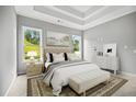Serene main bedroom with tray ceilings, natural light, and a luxurious ensuite bathroom at 1101 Cooks Farm Way, Woodstock, GA 30189