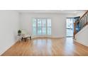 Elegant living room with light wood floors, shuttered bay window, and ample natural light at 136 Peachtree Memorial Nw Dr # Nj2, Atlanta, GA 30309