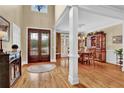 Grand foyer showcasing hardwood floors, decorative columns, and entry to the formal dining room at 1477 Edenham Ln, Cumming, GA 30041