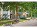Modern condo building with landscaped green space and beautiful trees at 22 Moda Ln, Atlanta, GA 30316