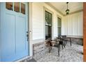 Inviting front porch with a comfortable seating area and stylish light fixture at 2861 Digna Ct, Acworth, GA 30101