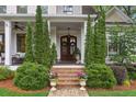 Inviting front porch with detailed trim work and lush landscaping at 194 Locust Nw St, Marietta, GA 30064